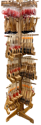 A freestanding wooden display stand filled with multiple bowfishing arrows and a branded sign at the top reading 'Outdoor Adventure Bowfishing'. The stand is photographed on a plain white background.